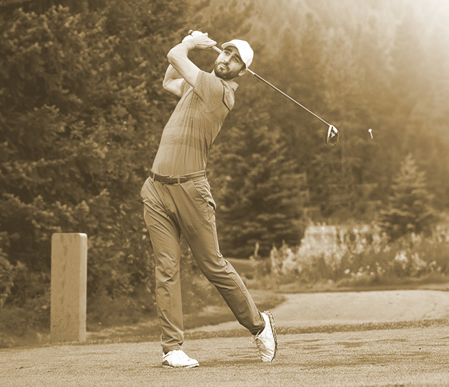 Golfer teeing off at sunrise, capturing the serene beauty of the course